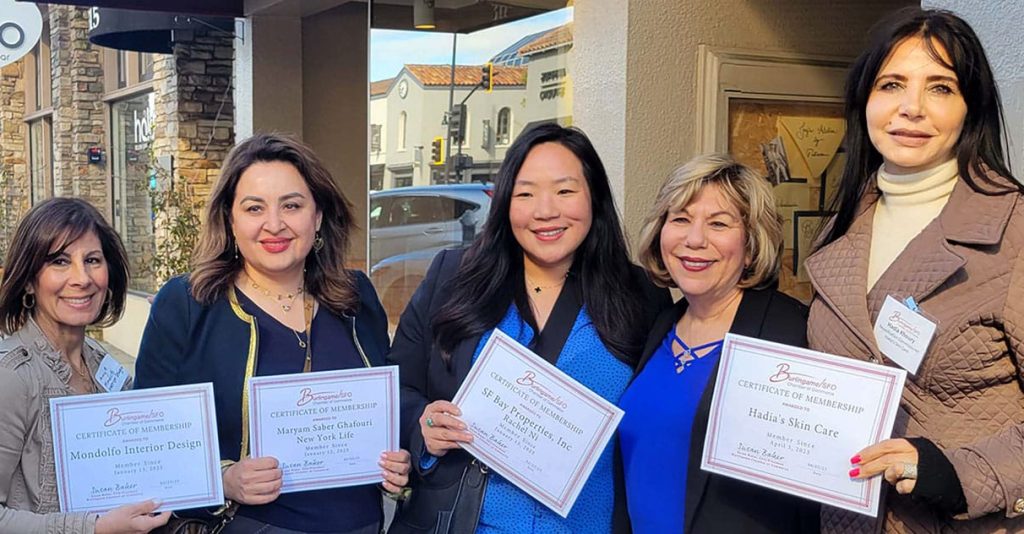 new members holding their certificates